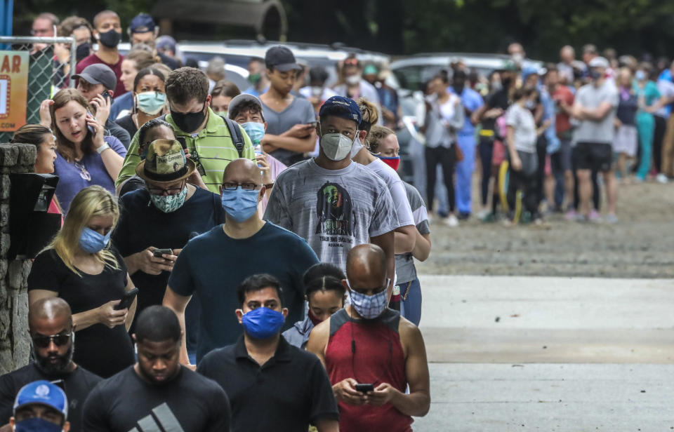 Voters wait in line before voting at the Park Tavern polling place in Atlanta on Tuesday, June 9, 2020. (John Spink/Atlanta Journal-Constitution via AP)