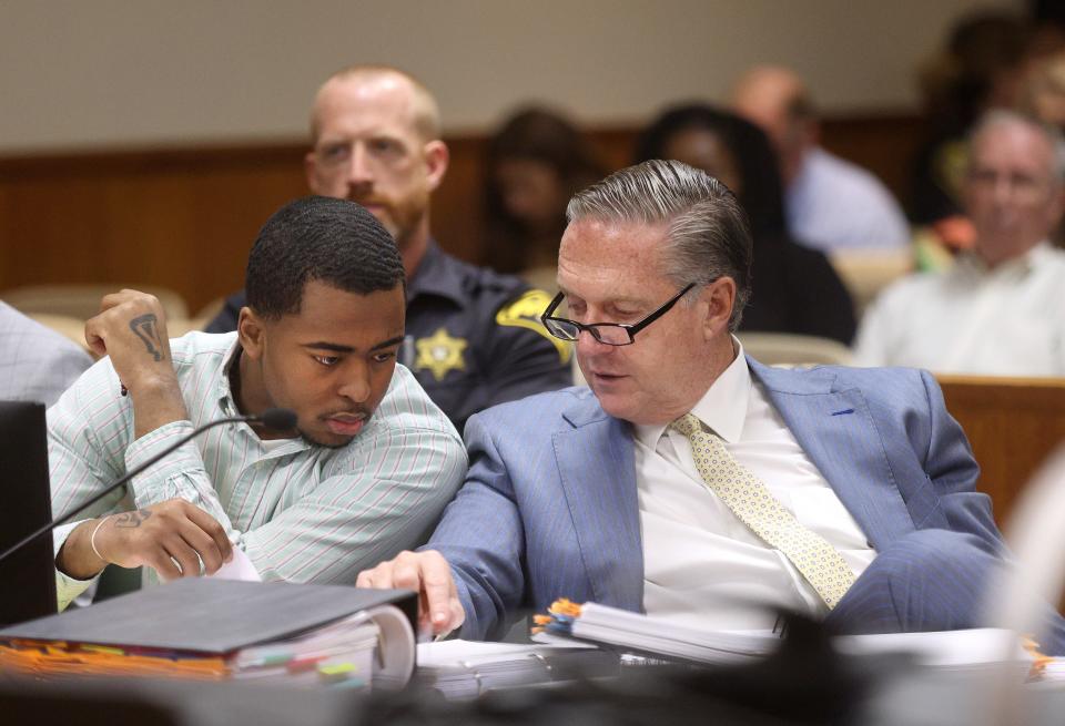 Kelvin Vickers and his attorney Michael Schiano converse during the opening statement portion of Vickers murder trial. Vickers faces multiple charges including the murder of Rochester Police Officer Anthony Mazurkiewicz.
