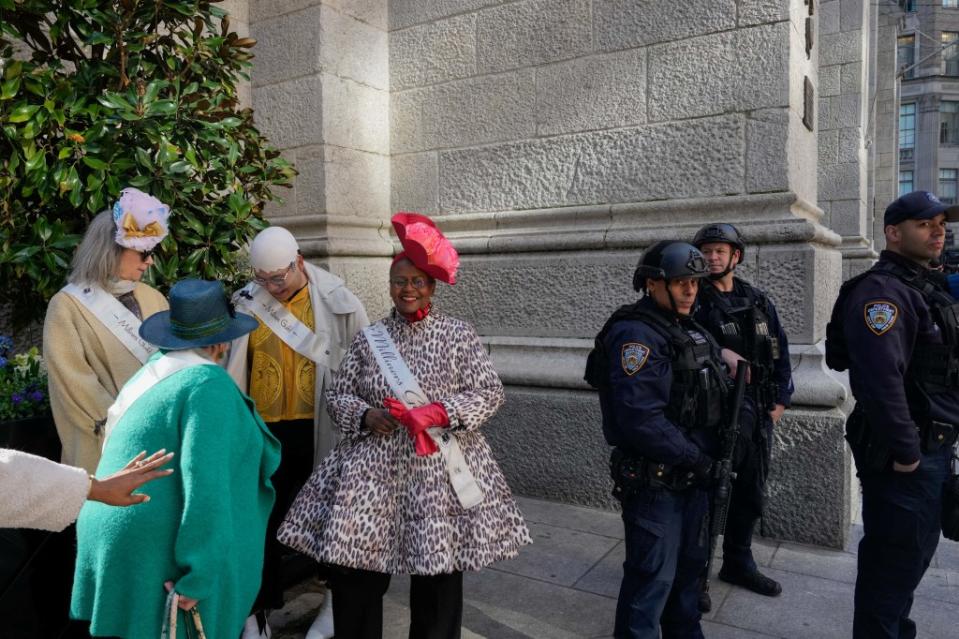 NYPD officers armed with rifles stand guard as revelers take part in the annual Easter Parade and Bonnet festival outside St. Patrick’s Cathedral. REUTERS