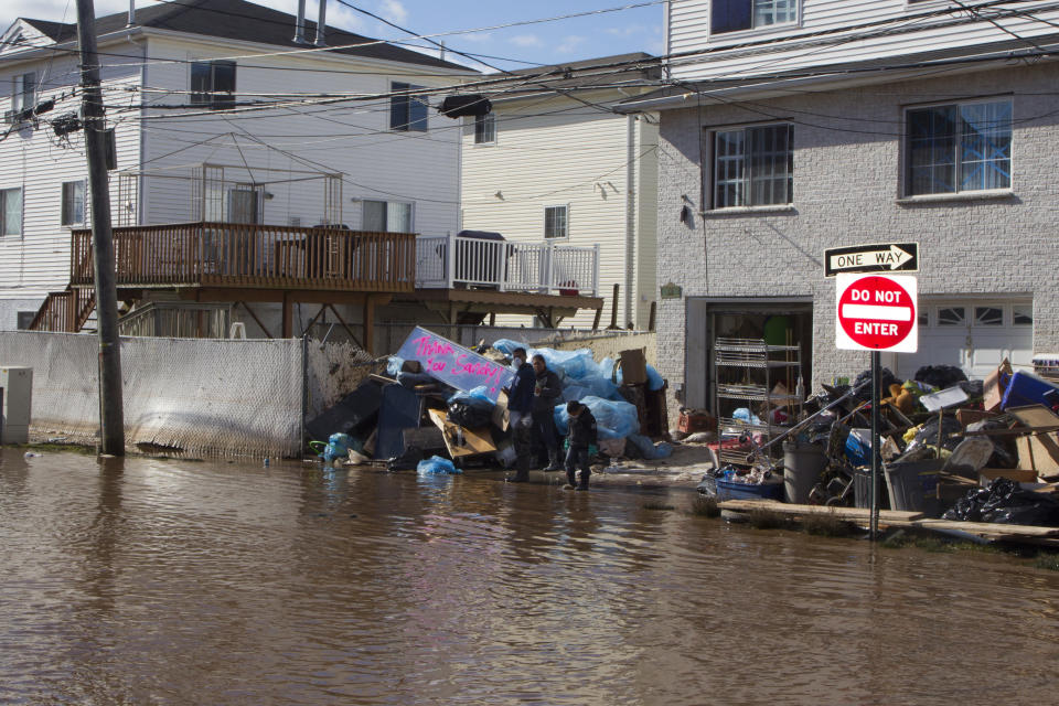 A family cleans up after Hurricane Sandy's surging waters flooded their home in the Midland Beach section of Staten Island