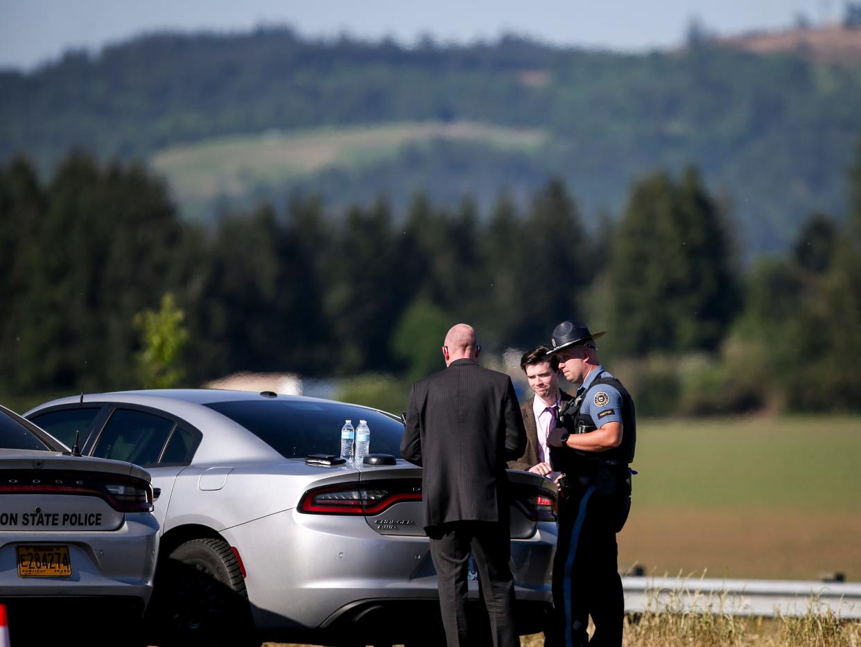 Law enforcement officers talk along northbound Interstate 5 in Marion County where seven farmworkers were killed in a three-vehicle crash on May 18.