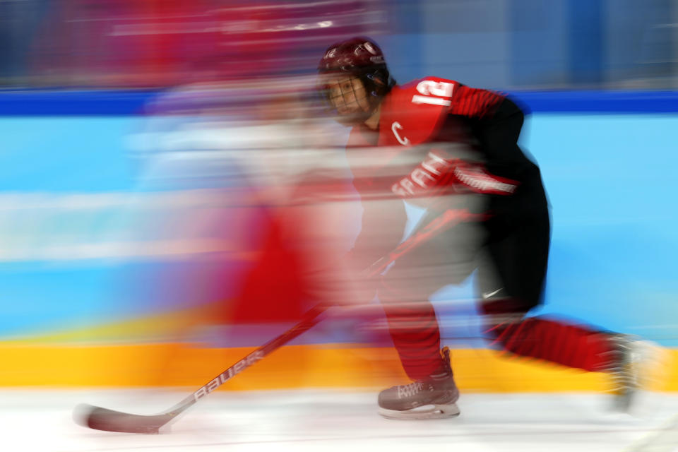 Japan's Chiho Osawa (12) moves the puck during a preliminary round women's hockey game against Denmark at the 2022 Winter Olympics, Saturday, Feb. 5, 2022, in Beijing. (AP Photo/Petr David Josek)
