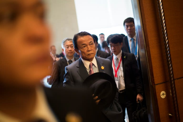 Japan's Deputy Prime Minister Taro Aso (C) arrives to attend one of the G20 finance ministers' meetings, in Chengdu, China's Sichuan province, on July 23, 2016