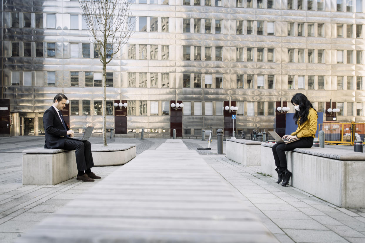 Business people keeping distance working outdoors