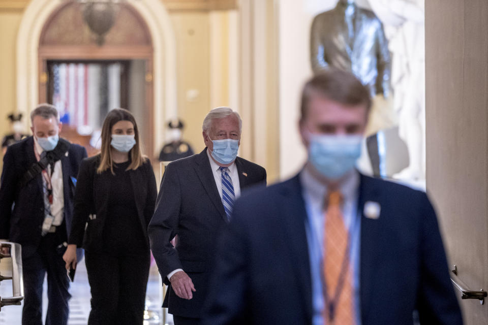 House Majority Leader Steny Hoyer of Md., second from right, walks off of the House floor on Capitol Hill, Thursday, April 23, 2020, in Washington. The House is expected to vote on a nearly $500 billion Coronavirus relief bill. (AP Photo/Andrew Harnik)