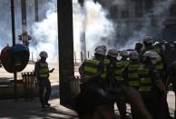 Police officers take position as they face demonstrators during a protest against Brazilian President Jair Bolsonaro in Sao Paulo