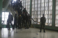 Soldiers guarding the military junta led by Col. Mamady Doumbouya, during a meeting at the people's palace in Conakry, Guinea Wednesday, Sept. 15, 2021. Guinea's junta is expected to face more pressure to set a timeframe for new elections Tuesday as the military rulers open a four-day series of meetings about the West African nation's future following the president's overthrow in a coup just over a week ago. (AP Photo/Sunday Alamba)