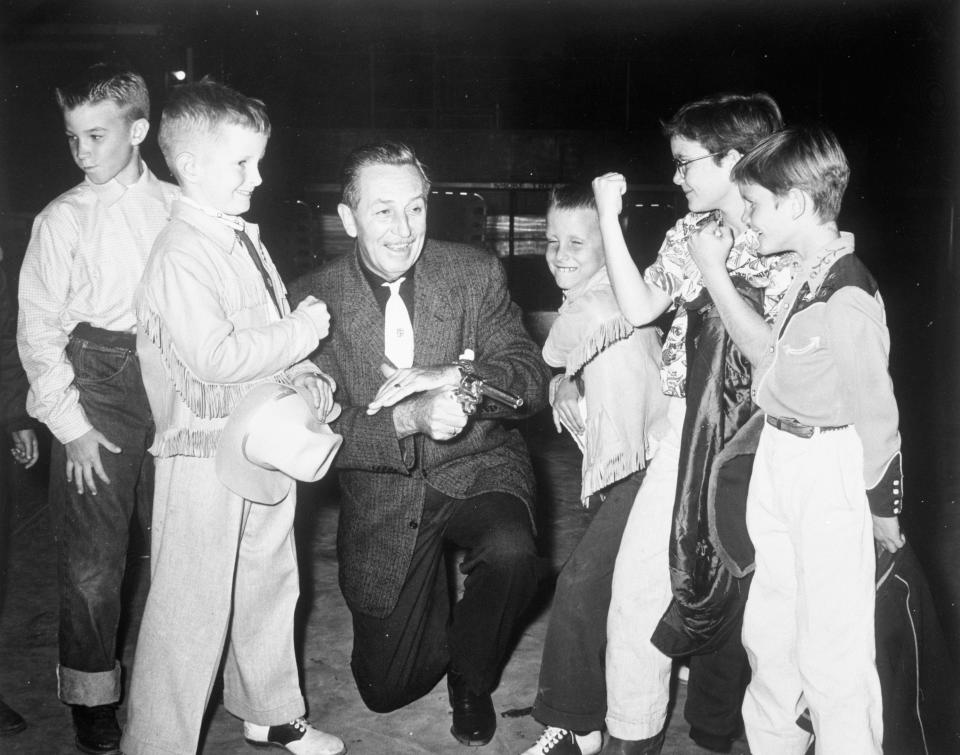 Walt Disney surrounded by children at Smoke Tree Ranch in Palm Springs.