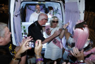 LAS VEGAS - OCTOBER 1: (L-R) The Rev. Andy Gonzalez performs a wedding between Thomas Rogers and Catherine Metcalf from England at the Las Vegas Wedding Wagon on October 1, 2012 in Las Vegas, Nevada. For USD 99, ordained ministers will drive a van with an altar to any location in and around Las Vegas and perform a legal wedding, vow renewal or commitment ceremony in about 10 minutes. The fee includes wedding photos but not a marriage license. Couples can either get hitched at the Wedding Wagon's walk-up window or at iconic areas including the Welcome to Fabulous Las Vegas sign, the fountains at the Bellagio, the Hoover Dam and pedestrian bridges overlooking the Las Vegas Strip. (Photo by Isaac Brekken/Getty Images)