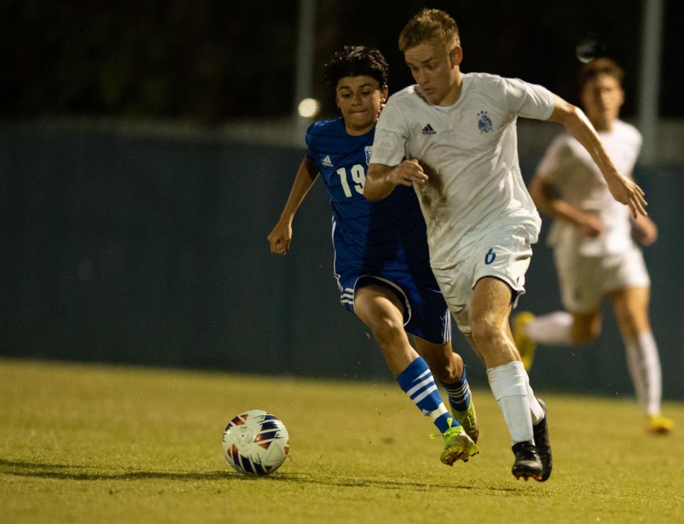 Castle’s Ryker Kotmel (6) takes the ball down the field while being defended by Memorial’s Tristan Tas (19) during the Castle Knights vs Memorial Tigers game at Memorial High School in Evansville, Ind., Wednesday evening, Sept. 14, 2022. 