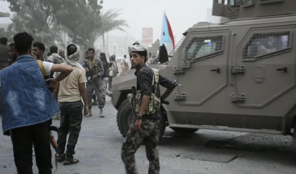 In this Friday Aug. 9, 2019 frame grab from video, Southern Transitional Council separatist fighters prepare to storm the presidential palace in the southern port city of Aden, Yemen. The separatists backed by the United Arab Emirates began withdrawing Sunday from positions they seized from the internationally-recognized government in Aden. Both the southern separatists and the government forces are ostensibly allies in the Saudi-led military coalition that’s been battling the Houthi rebels in northern Yemen since 2015, but the four days of fighting in Aden have exposed a major rift in the alliance. (AP Photo)