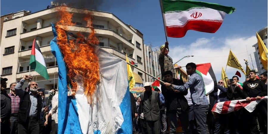 Iranians in Tehran burn an Israeli flag during a rally marking Quds Day and the funeral of Islamic Revolutionary Guard Corps members killed in Israeli airstrike on the Iranian embassy in the Syrian capital Damascus, April 5, 2024