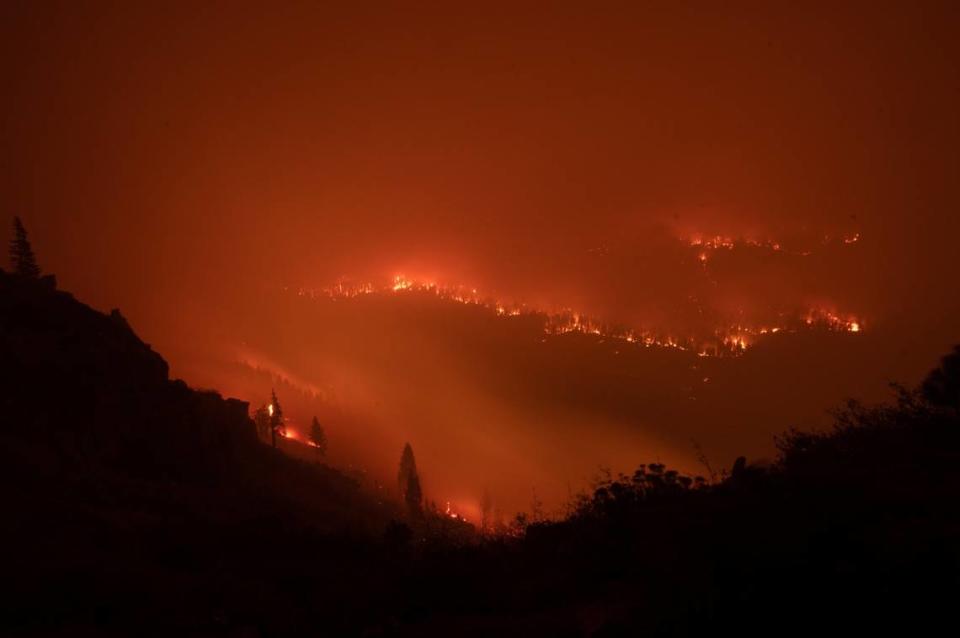 The Caldor Fire advances toward homes and buildings near Highway 89 in Christmas Valley in the Tahoe Basin on Monday, Aug. 30, 2021.