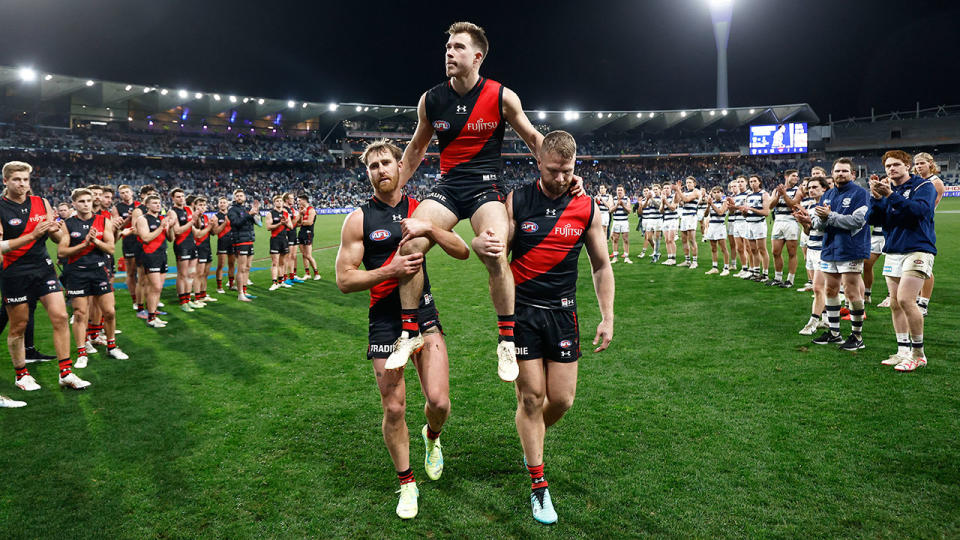 Seen here, Essendon's 200-game AFL milestone man Zach Merrett is given a guard of honour.