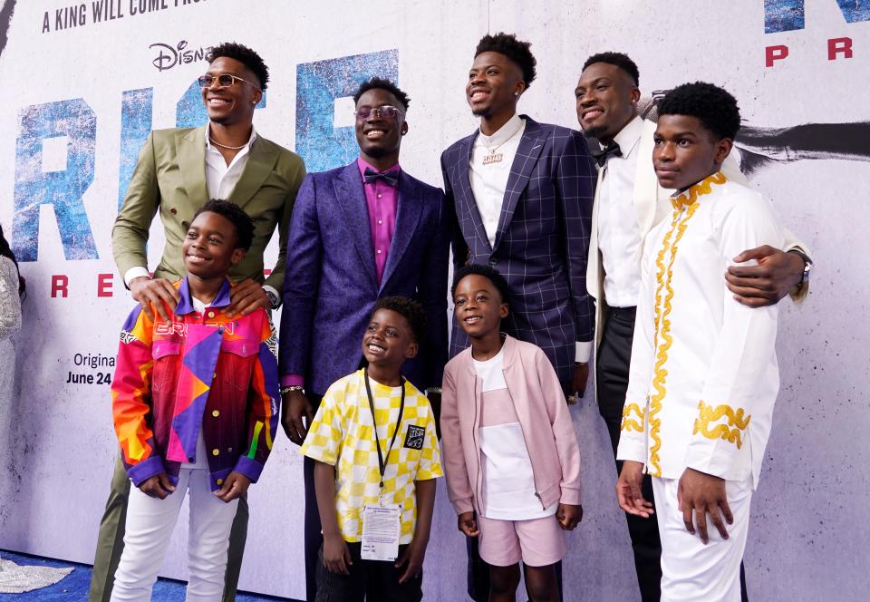 Top row, from left, brothers Giannis, Alex, Kostas and Thanasis Antetokounmpo pose alongside the actors who portray them, bottom row from left, McColm Celphas Jr., Jahleel Kamara, Aaron Kingsley Adetola and Chinua Baraka Payne at the premiere of the Disney+ film "Rise".