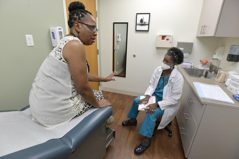 At Life Tree Women Care, first-time patient Jacqueline Fletcher talks with co-owner Jamie Neal, a registered nurse practitioner and midwife, as she ponders moving her medical care to the practice.