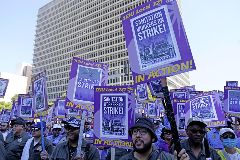 Workers picket outside of City Hall Tuesday, Aug. 8, 2023, in Los Angeles. Thousands of Los Angeles city employees, including sanitation workers, engineers and traffic officers, walked off the job for a 24-hour strike alleging unfair labor practices. The union said its members voted to authorize the walkout because the city has failed to bargain in good faith and also engaged in labor practices that restricted employee and union rights. (AP Photo/Ryan Sun)