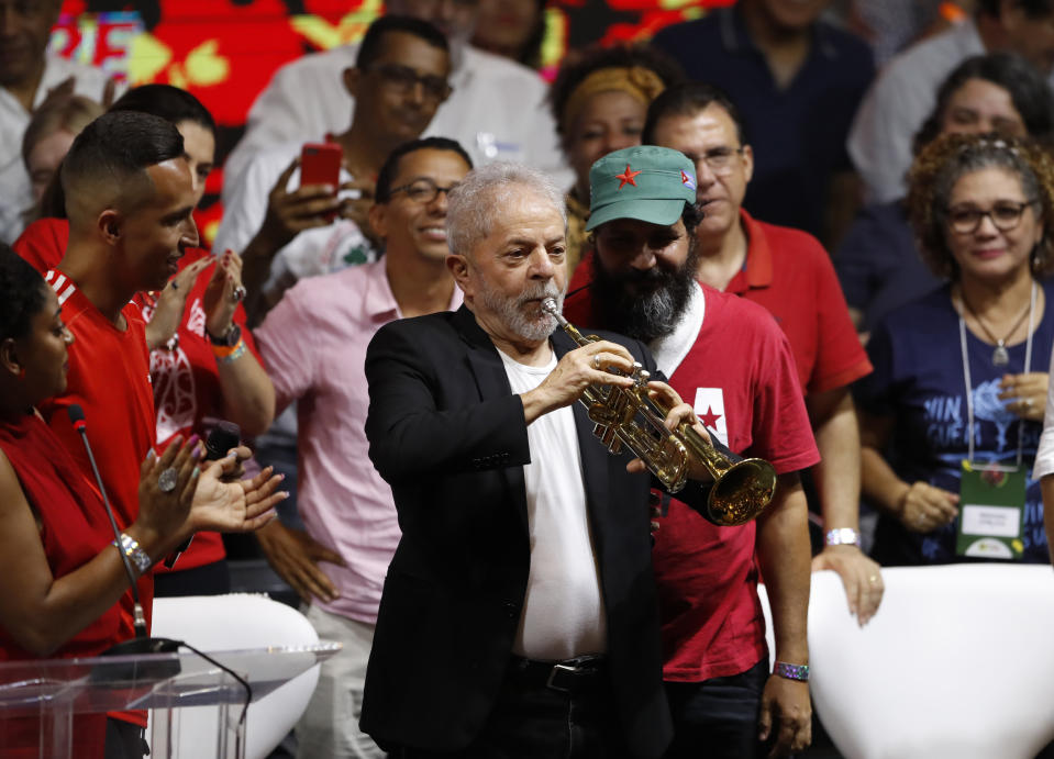 Former Brazilian President Luiz Inacio Lula da Silva plays a trumpet during the Workers' Party 7th Congress, in Sao Paulo, Brazil, Friday, Nov. 22, 2019. Da Silva is the unquestioned star of the PT 3-day party convention. Many still think he could be the party's standard-bearer once again in 2022 - when he'll be a 77-year-old cancer survivor who is now barred from seeking office due to a corruption conviction. (AP Photo/Nelson Antoine)