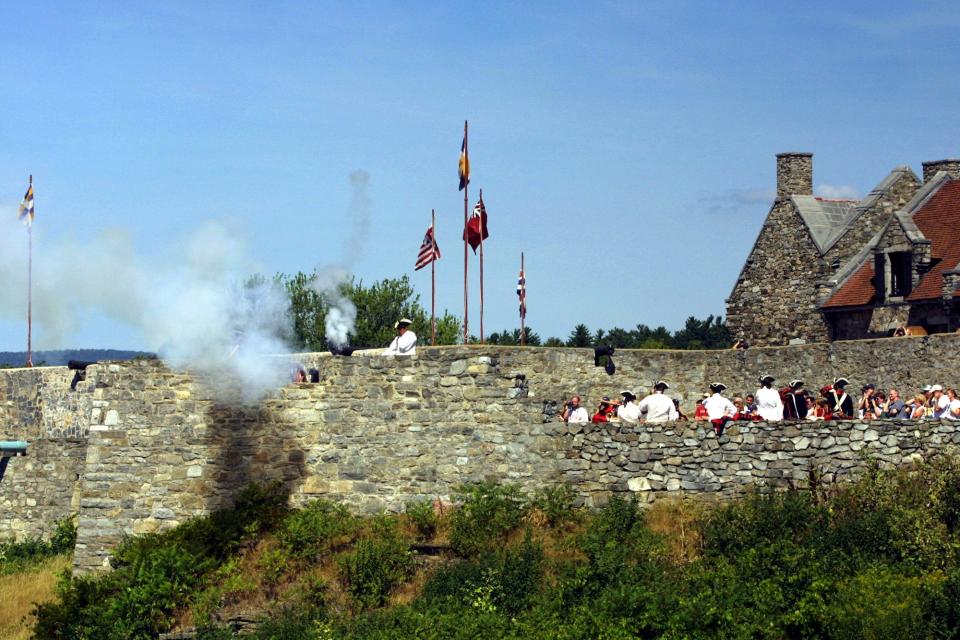 Fife & Drum Corps Drum Major Mike Edson fires a three-pound field piece, smoke, Aug. 21, 2002, at  Fort Ticonderoga in Ticonderoga, New York. The display was to demonstrate the artillery used 225 years ago when the Americans occupied this fort which was originally started in 1755 by the French during the French and Indian Wars on Lake Champlain.