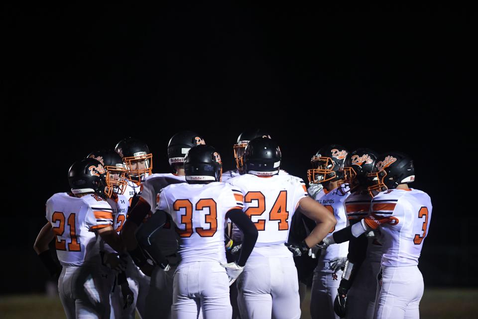 Dell Rapids football players huddle during a time out on Thursday, October 29, in the Class 11A playoffs at West Central High School in Hartford.