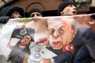 Russian protesters hold a placard and shout slogans in front of the Turkish embassy in Moscow on November 25, 2015