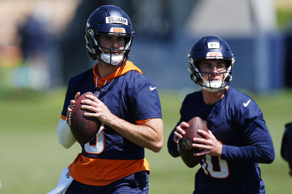 Denver Broncos quarterbacks Jarrett Stidham, left, rookie Bo Nix take part in drills during practice at the NFL football team's training headquarters Thursday, May 23, 2024, in Centennial, Colo. (AP Photo/David Zalubowski)