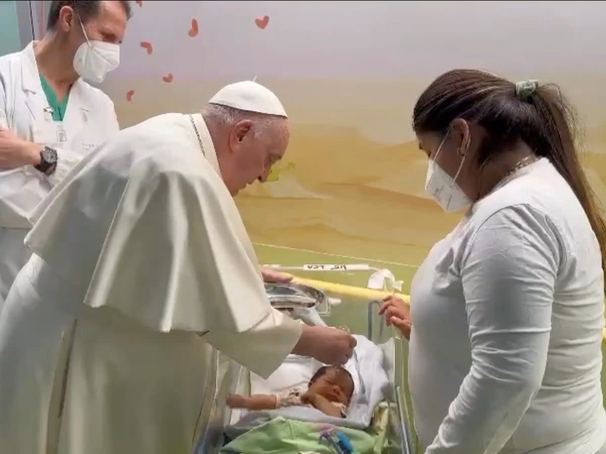 Pope Francis baptises a baby boy called Miguel Angel (Vatican Media via Reuters)