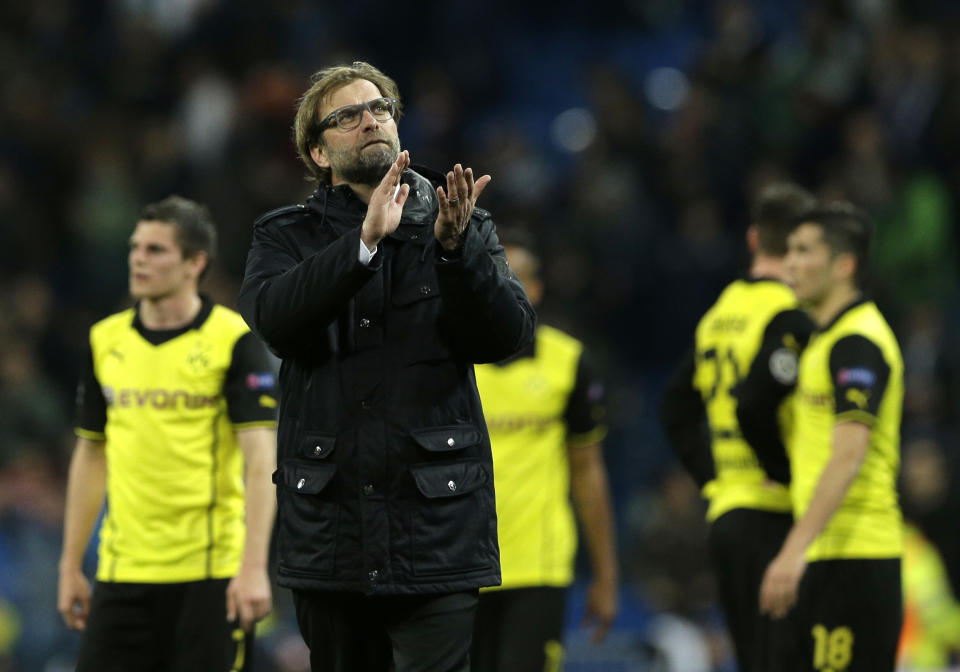 Dortmund head coach Juergen Klopp waves to Dormund supporters at the end of the Champions League quarterfinal first leg soccer match between Real Madrid and Borussia Dortmund at the Santiago Bernabeu stadium in Madrid, Spain, Wednesday April 2, 2014. (AP Photo/Paul White)