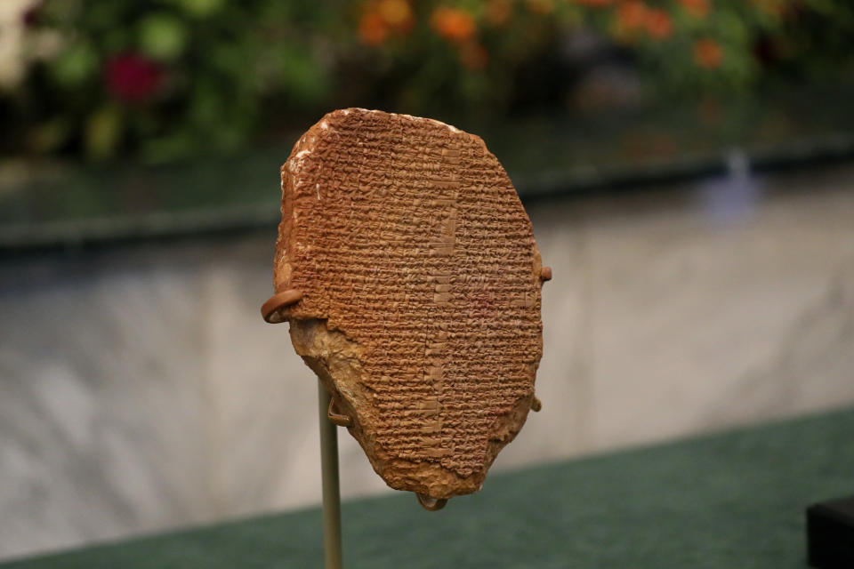 A recovered clay tablet from the United States is displayed at the Ministry of Foreign Affairs, Baghdad, Iraq, Tuesday, Dec. 7, 2021. The 3,500-year-old clay tablet bearing a portion of the Epic of Gilgamesh that was looted from an Iraqi museum 30 years ago was formally returned to Iraq Monday. (AP Photo/Khalid Mohammed)