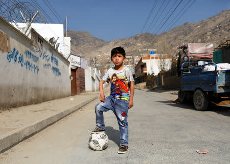 Murtaza Ahmadi, 7, an Afghan Lionel Messi fan, plays football outside his house in Kabul, Afghanistan December 8, 2018. REUTERS/Mohammad Ismail