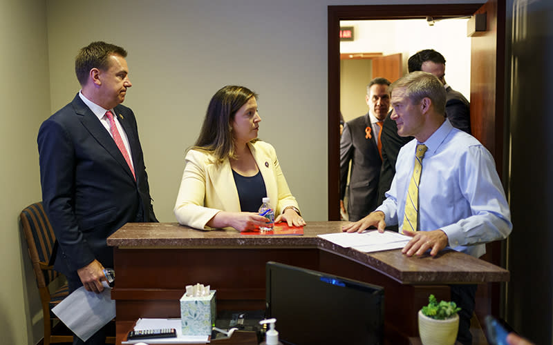 Richard Hudson, left, Elise Stefanik, center, and Jim Jordan, right converse before a press conference