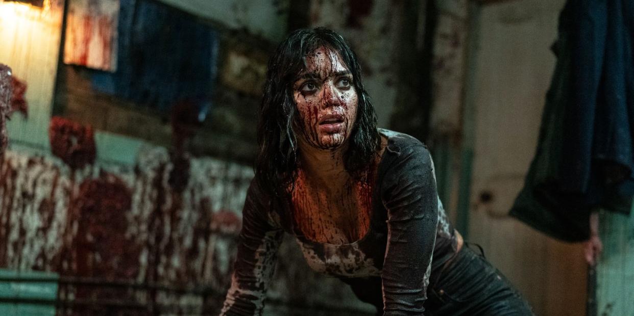 melissa barrera as joey covered in blood in abigail movie