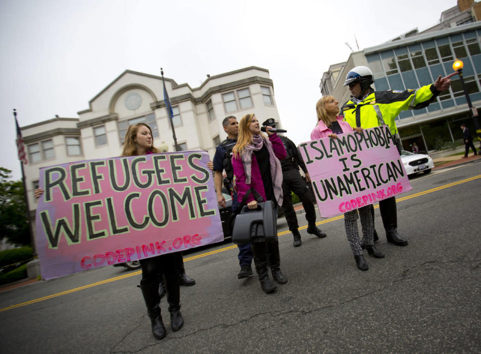 Members of CodePink are escorted by law enforcement officer across the street after the arrival of Republican presidential candidate Donald Trump at the National Republican Senatorial Committee (NRSC) building in Washington, Thursday, May 12, 2016. Trump is scheduled to meet with Senate Majority Leader Mitch McConnell of Ky., and other Senate GOP leadership. (AP Photo/Pablo Martinez Monsivais)