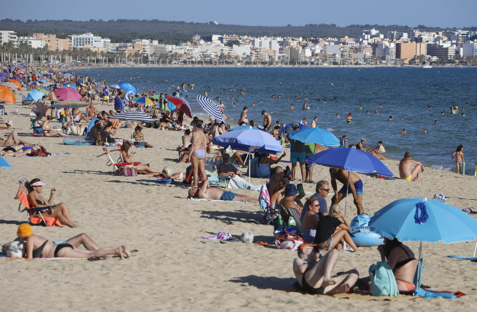 19 July 2020, Spain, Palma de Mallorca: People enjoy the sun on the beach of El Arenal. While bars have been closed on party miles in Mallorca, the beaches are still open. Photo: Clara Margais/dpa (Photo by Clara Margais/picture alliance via Getty Images)