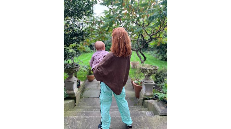 stacey dooley holding baby on steps 