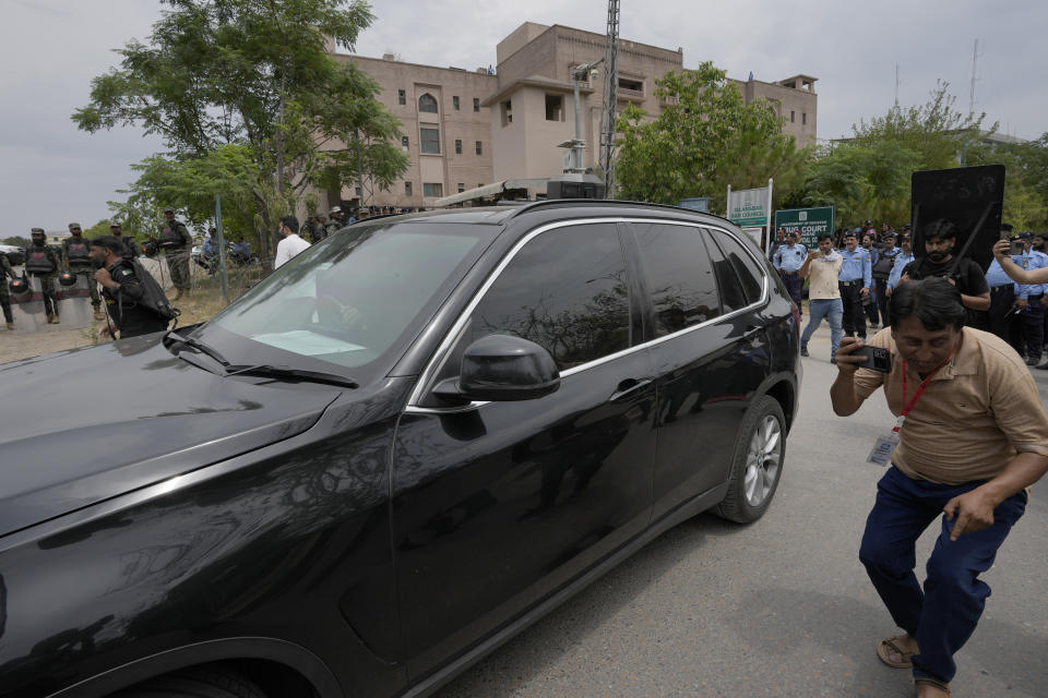 A vehicle carrying the Pakistan's former Prime Minister Imran Khan leaves after his court appearance, in Islamabad, Pakistan, Tuesday, May 23, 2023. Khan on Tuesday pressed his legal battle before a court in the capital, Islamabad, which granted him protection from arrest until early next month in several cases where he faces terrorism charges for inciting violence. (AP Photo/Anjum Naveed)