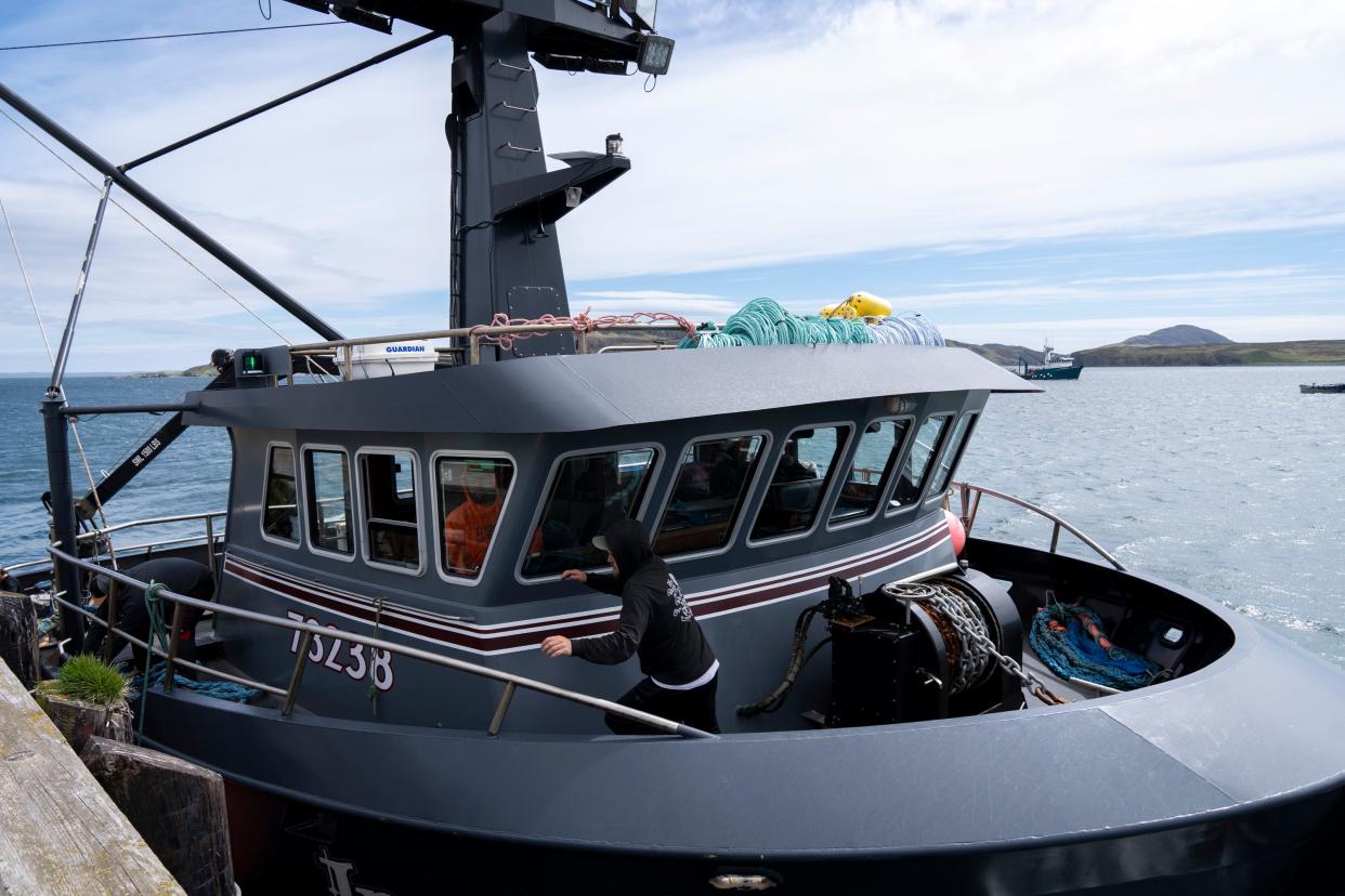 Grant Elvehjem rushes to untie the fishing vessel Insatiable from the dock in Lazy Bay at the southern end of Kodiak Island, home to a fishing cannery and the Alitak Seaplane Base.