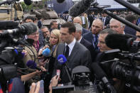 Jordan Bardella, president of the far-right National Front party, answers reporters after visiting the Eurosatory Defense and Security exhibition, Wednesday, June 19, 2024 in Villepinte, north of Paris. Jordan Bardella, hoping to become France's prime minister, appealed Tuesday to voters to hand his party a clear majority after French President Emmanuel Macron's announcement on June 9 that he was dissolving France's National Assembly, parliament's lower house.( AP Photo/Michel Euler)