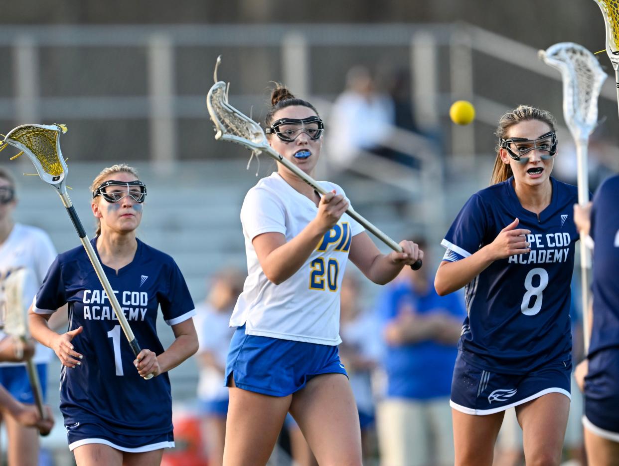 Sophie Philbrick of St. John Paul II puts a shot on Cape Cod Academy goal surrounded by Reese Moreshead (8) and Livy Daigle.