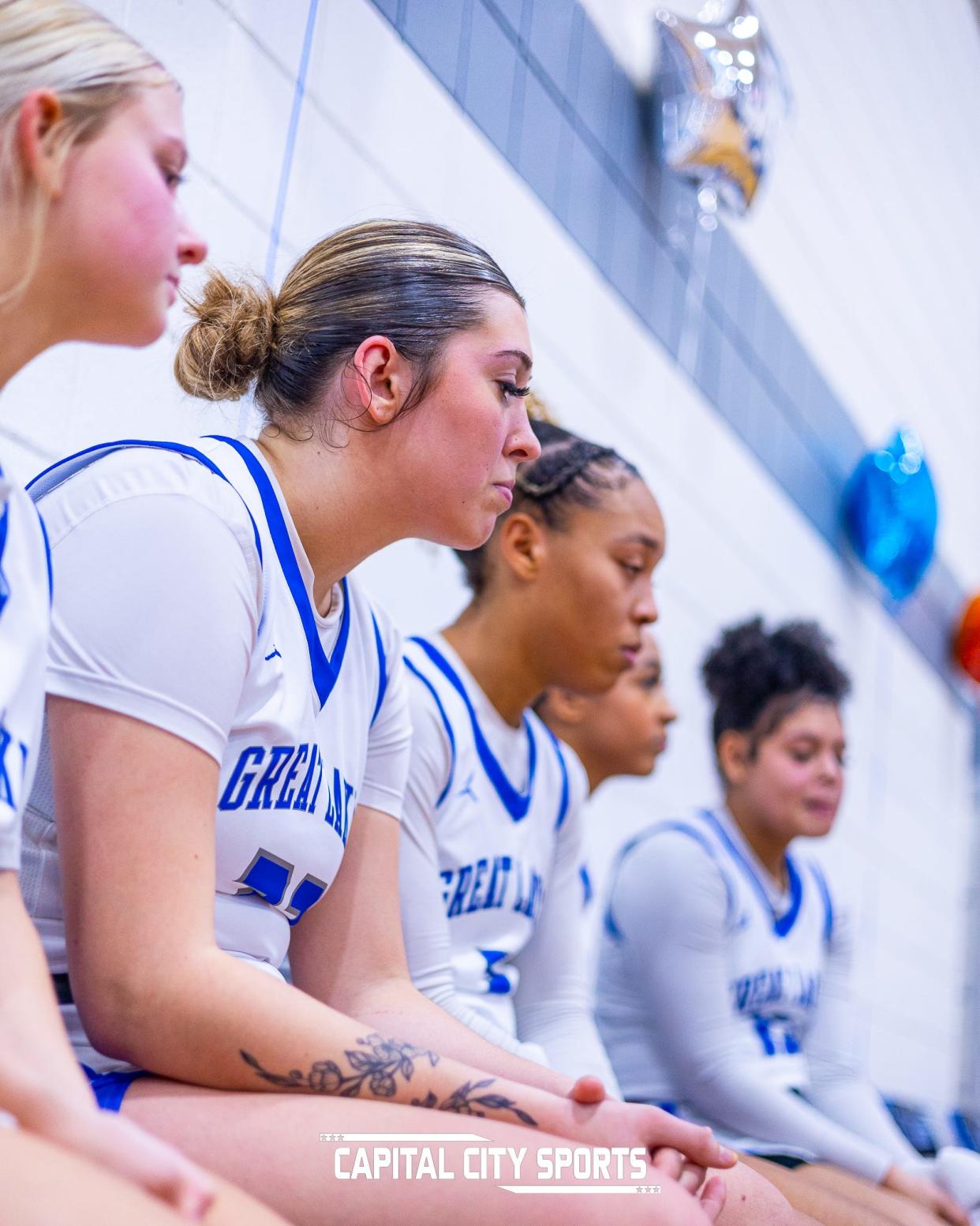 Great Lakes Christian College's women's basketball team listens to instructions on the bench.