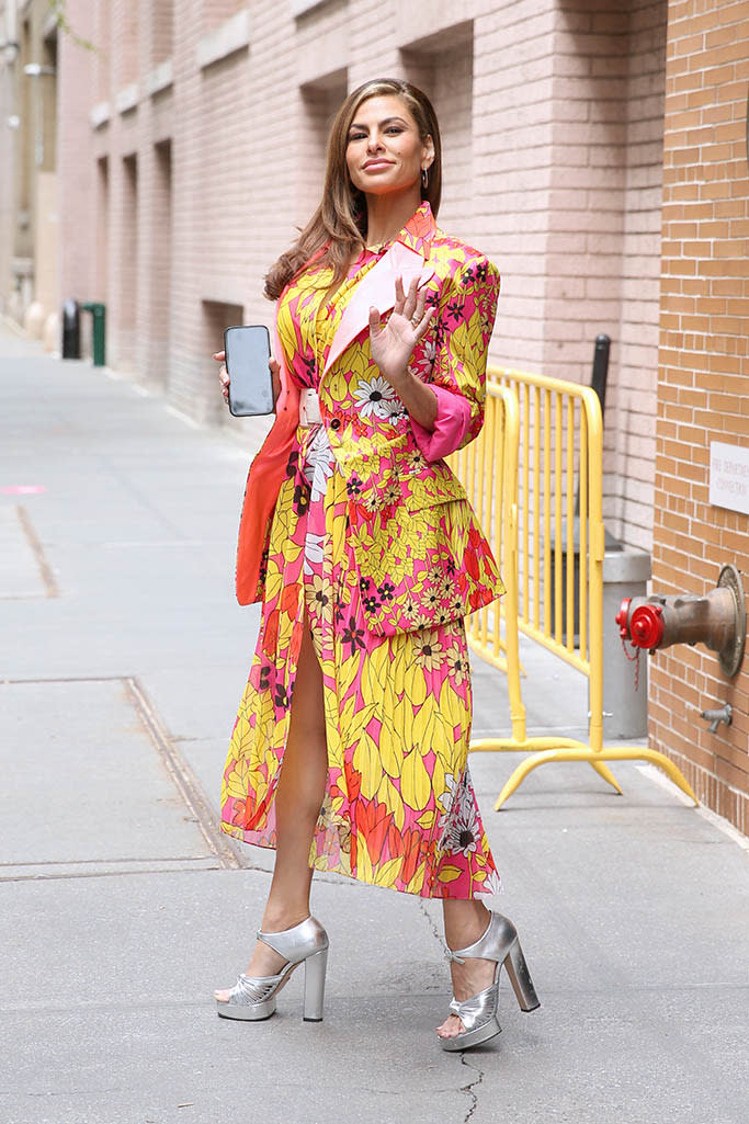 Eva Mendes wears a colorful yellow dress and silver platform high heels at “The View” in New York on May 3, 2022. - Credit: Christopher Peterson / SplashNew