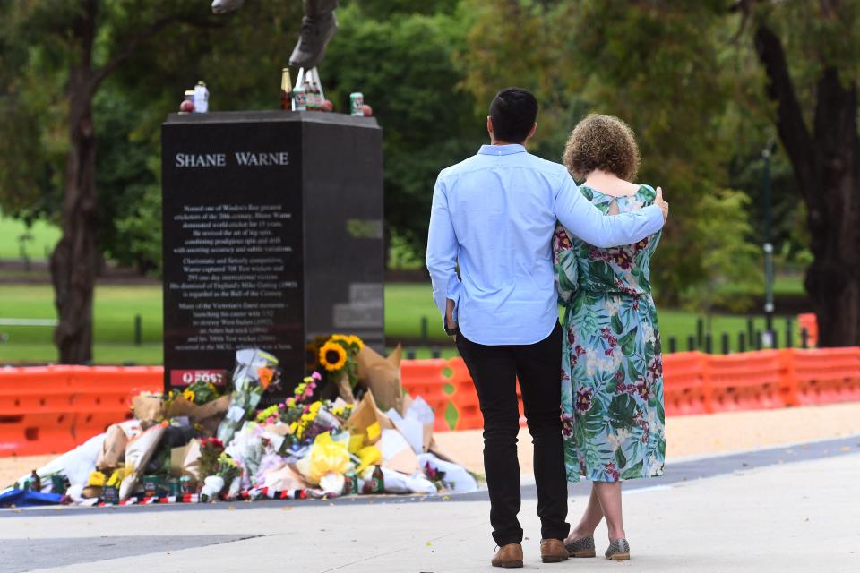 People, pictured here paying their respects at Shane Warne's statue outside the MCG.