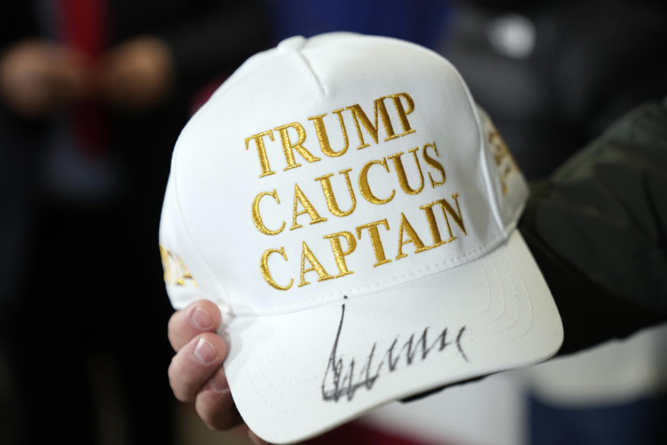 A person holds a hat that Republican presidential candidate former President Donald Trump signed after he spoke at a rally at Des Moines Area Community College in Newton, Iowa, Saturday, Jan. 6, 2024. (AP Photo/Andrew Harnik)