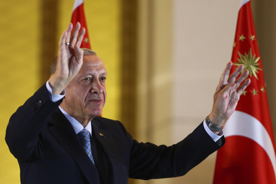 Turkish President and People's Alliance's presidential candidate Recep Tayyip Erdogan gestures to supporters at the presidential palace, in Ankara, Turkey, Sunday, May 28, 2023. Turkey President Recep Tayyip Erdogan won reelection Sunday, extending his increasingly authoritarian rule into a third decade as the country reels from high inflation and the aftermath of an earthquake that leveled entire cities. (AP Photo/Ali Unal)