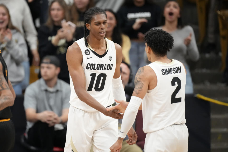 Colorado forward Cody Williams, left, is congratulated by guard KJ Simpson after he was fouled on a dunk during the first half of the team's NCAA college basketball game against Milwaukee on Tuesday, Nov. 14, 2023, in Boulder, Colo. (AP Photo/David Zalubowski)