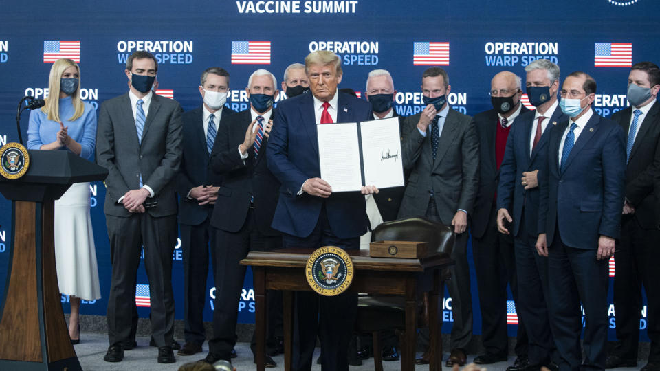 U.S. President Donald Trump holds a signed executive order during an Operation Warp Speed vaccine summit at the White House in Washington, D.C., U.S., on Tuesday, Dec. 8, 2020. (Al Drago/Bloomberg via Getty Images)