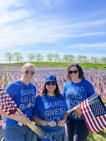 <p>Baird</p> Associates from Baird’s headquarters in Milwaukee plant flags at the Milwaukee War Memorial to commemorate Memorial Day 2024.