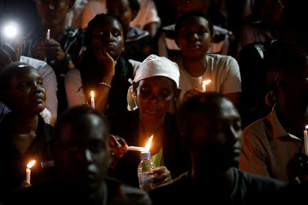 Participants hold candles while holding a night vigil during a commemoration ceremony marking the 25th anniversary of the Rwandan genocide, at the Amahoro stadium in Kigali, Rwanda April 7, 2019. REUTERS/Baz Ratner