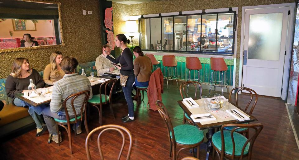 People in the dining area get a front row seat to view the action in the kitchen at the new Square Scullery restaurant, Monday, Jan. 29, 2024, in Akron, Ohio.