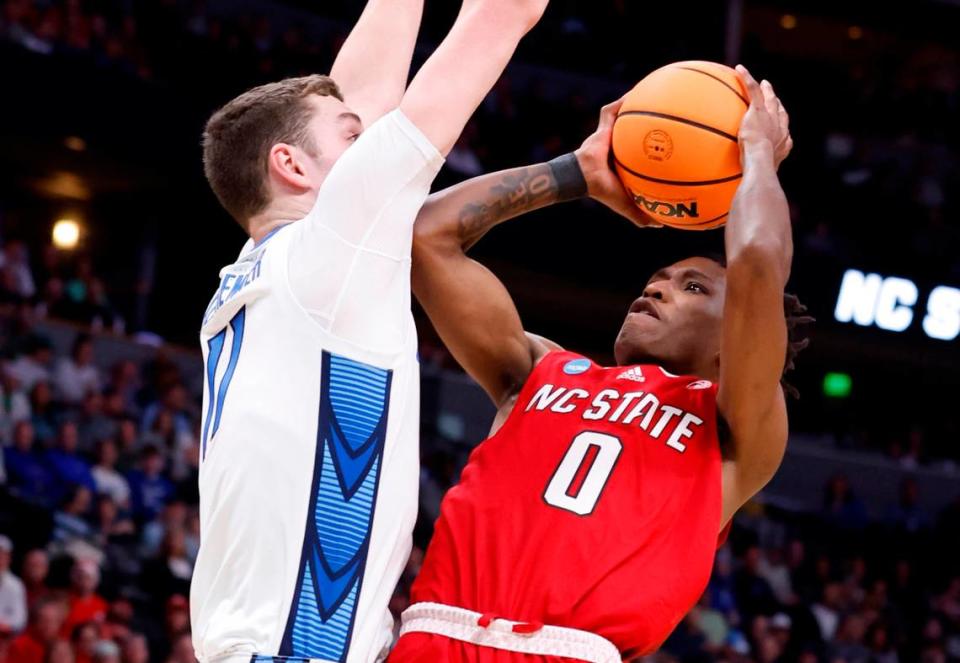 N.C. State’s Terquavion Smith (0) shoots as Creighton’s Ryan Kalkbrenner (11) defends during the first half of N.C. State’s game against Creighton in the first round of the NCAA Tournament at Ball Arena in Denver, Colo., Friday, March 17, 2023. Ethan Hyman/ehyman@newsobserver.com